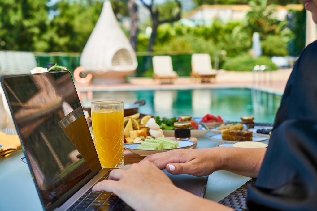 Person sitting at pool enjoying life due to api as a passive income stream